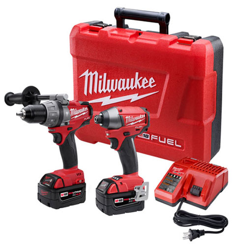 A Milwaukee tool set featuring a drill and impact driver, both with red and black design, accompanied by two battery packs and a charger, all housed in a sturdy red case.