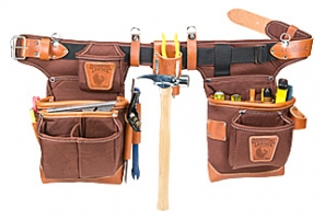 A brown and black tool belt with multiple pockets, holders for tools like a hammer and pencils, featuring a leather strap and adjustable buckle.