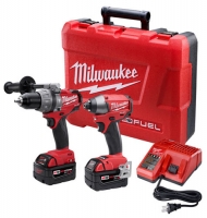 A Milwaukee tool kit featuring two cordless drills, charging station, and two batteries, all housed in a red carrying case.