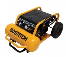 A BOSTITCH portable air compressor with a yellow tank and black body, featuring control gauges and wheels for mobility.