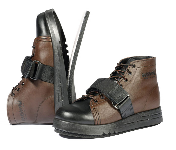 A pair of brown high-top shoes with black toe caps and a Velcro strap across the front. The shoes feature laces and a rugged design, suitable for outdoor or heavy-duty use.