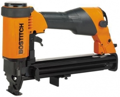 A Bostitch electric nail gun with an orange and black design, used for fastening materials together.