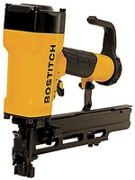 A BOSTITCH pneumatic nail gun with a yellow and black design, featuring a trigger and magazine for holding nails.