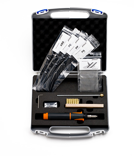 Open toolkit containing various components including filament samples, a brush, a metal tool, and a small accessory kit, all housed in a protective case.