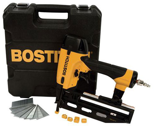 A Bostitch nail gun kit featuring a nail gun, a sturdy carrying case, and several nail strips arranged neatly in front.