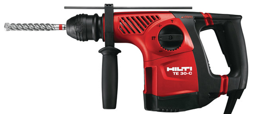 A Hilti TE 30-C rotary hammer drill featuring a red and black design with a spiral drill bit installed.