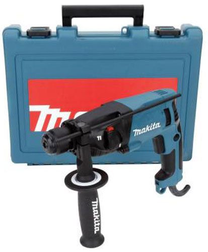 A Makita rotary hammer drill positioned next to its blue carrying case.