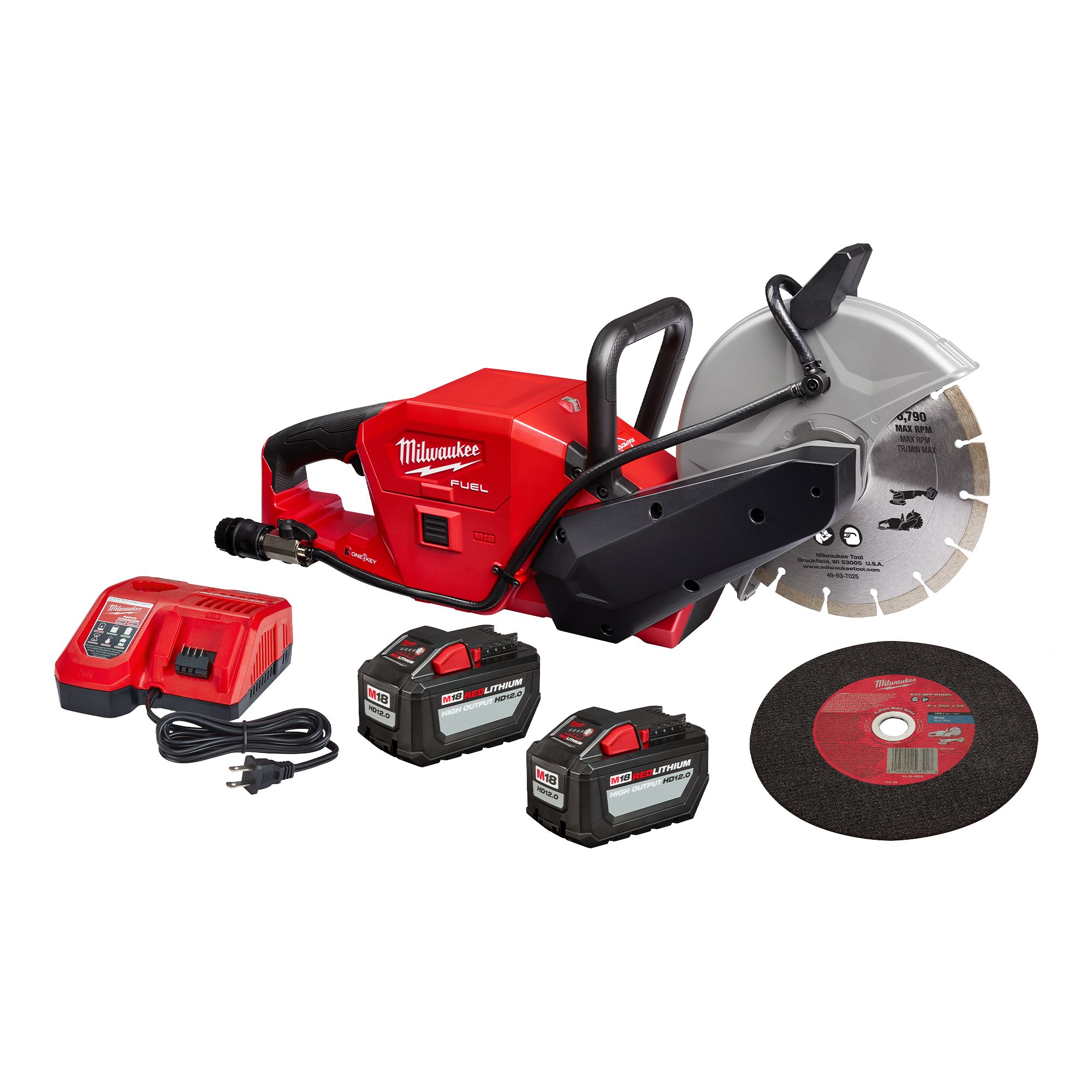 Cordless Milwaukee circular saw with two batteries, a charger, and an abrasive wheel